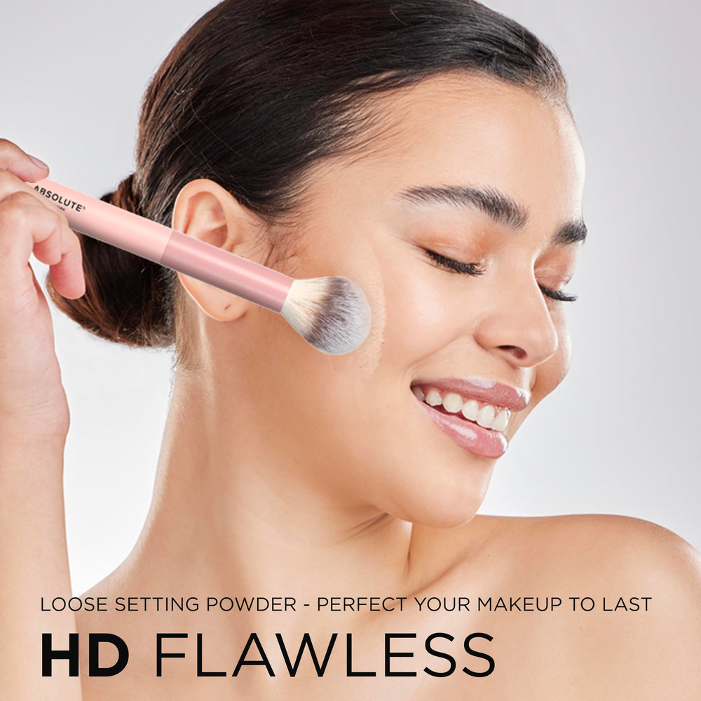 Absolute New York brush applying powder under eye, sets concealer for longer wear benefit