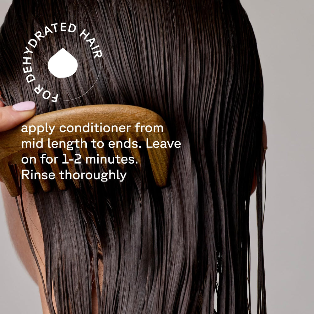 Acure conditioner rinsed in shower showing detangling and smoothing benefit