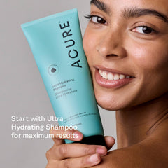Acure conditioner next to hand showing 8 fl oz size and travel-friendly benefit