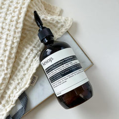 Aesop bottle beside kitchen sink showing suitability for frequent handwashing benefits