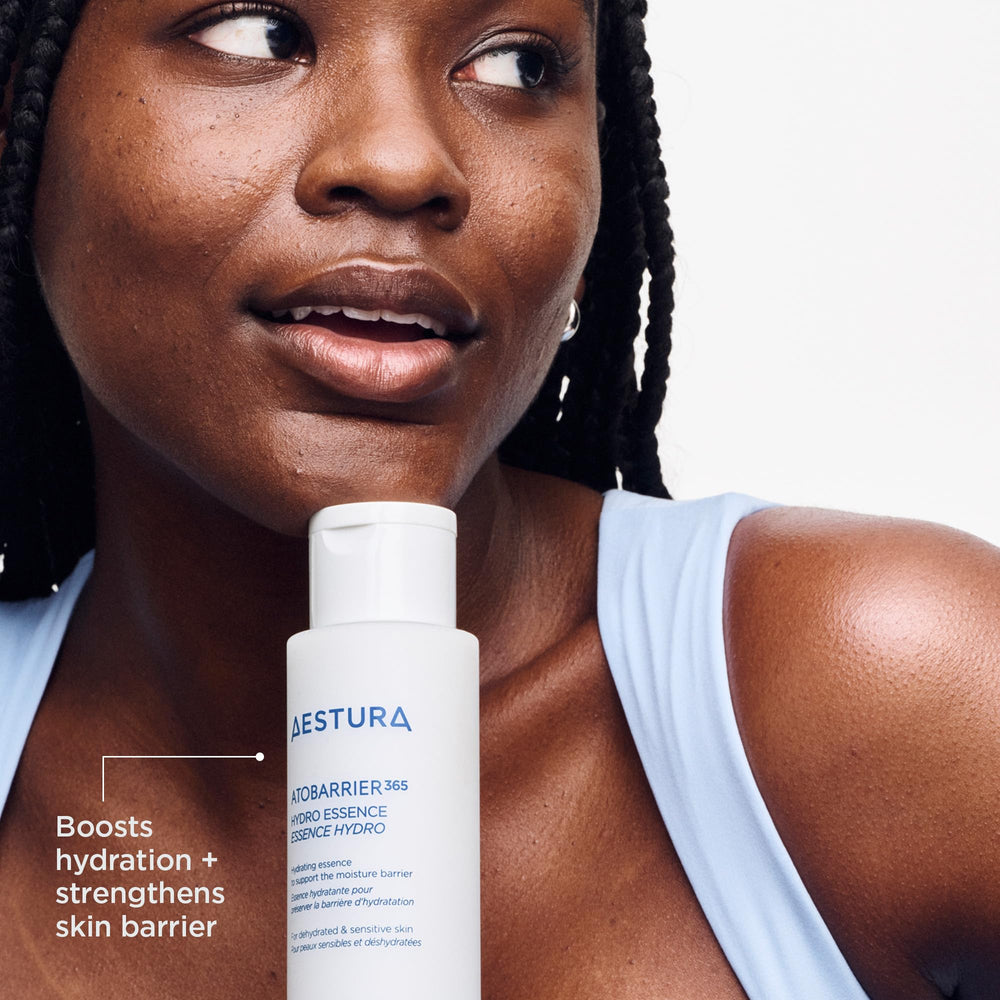 AESTURA 200ml bottle held next to a hand to show size and travel-friendly volume