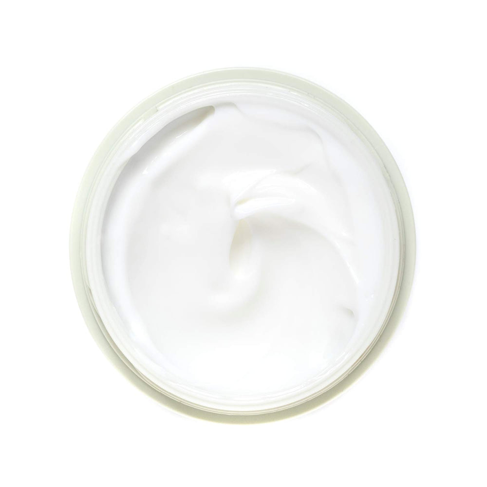 AHAVA cream held in hand to show 1.7 fl oz scale and portability benefit