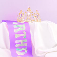 AHONEY crown beside a hand for scale to show one-size-fits-most dimensions