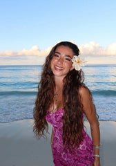 AIBFRID hibiscus clip worn in beach hairstyle adding tropical flair and photo-ready look