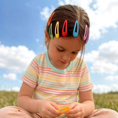Aigee mini bands holding a toddler ponytail demonstrating secure but gentle styling