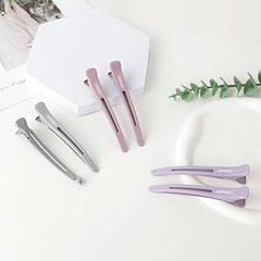 AIMIKE clip held in hand for scale showing compact, salon-ready size