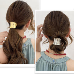 Ainvhh cuff beside a hair elastic showing compact 1.96-inch scale advantage