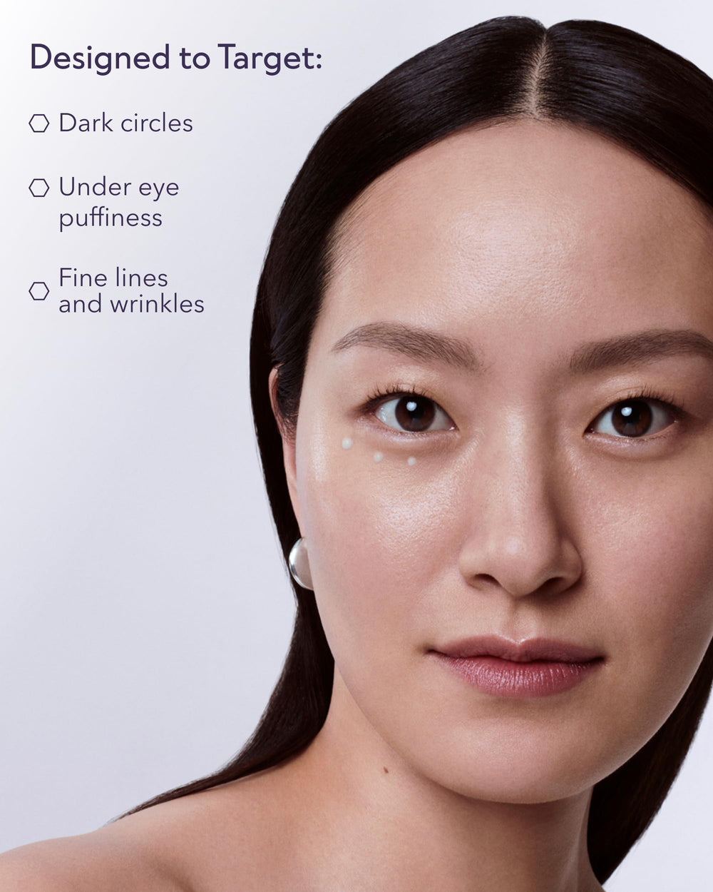 ALASTIN Skincare hand applying cream to under-eye demonstrating easy absorption
