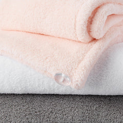 Person wearing Amazon Basics towel wrap secured with elastic band for convenience