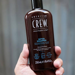 American Crew 8.45 fl oz bottle next to common items for scale