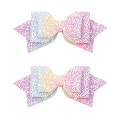 Amybasic front view of two rainbow glitter bows showing vibrant colors and secure clips, easy styling benefit