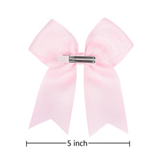 AMYDECOR bow worn in ponytail showing in-use stability benefit: stays put during play