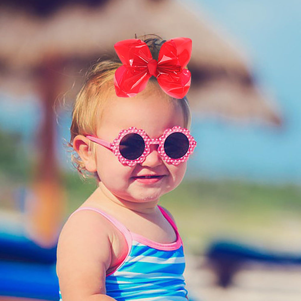 AMYDECOR red bow clipped in a little girl's hair offering playful summer style