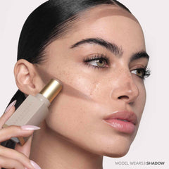 Anastasia Beverly Hills contour stick beside makeup bag showing travel-friendly convenience benefit