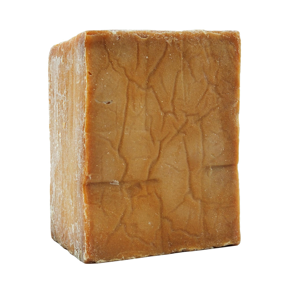 Anatolia Soap large bar beside a coin for scale showing value and long-lasting size