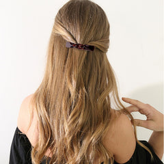 ANBALA clips in hand to show scale and lightweight convenience