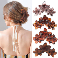 ANBALA front view of four plumeria clips showing colors and shape, for styling variety