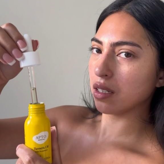 APTO oil on hand demonstrating lightweight feel and instant hydration