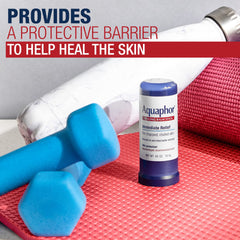 Hand holding Aquaphor stick to show compact 0.65 oz scale and easy carry benefit