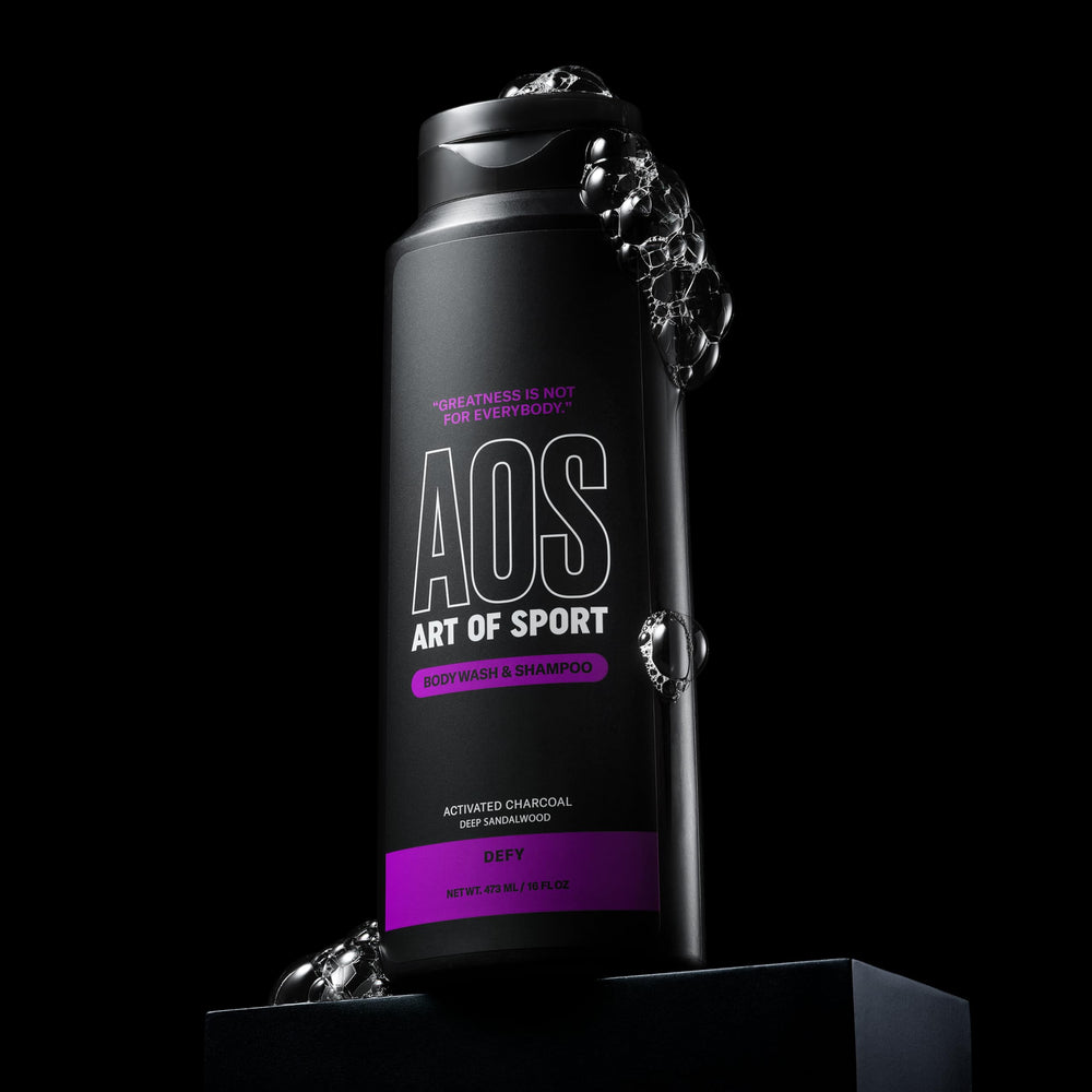 Art of Sport in-shower lifestyle shot showing athlete using two-in-one cleanser after workout