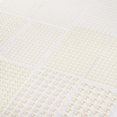 Artistbeauty pearls on wedding invitation showing elegant craft enhancement