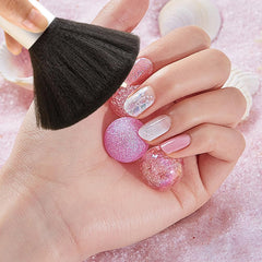 Arvintas brush in use during salon manicure removing acrylic dust efficiently