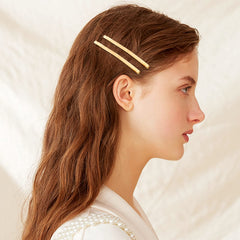 Aswewamt bobby pins held in palm demonstrating 2.56 inch length and scale