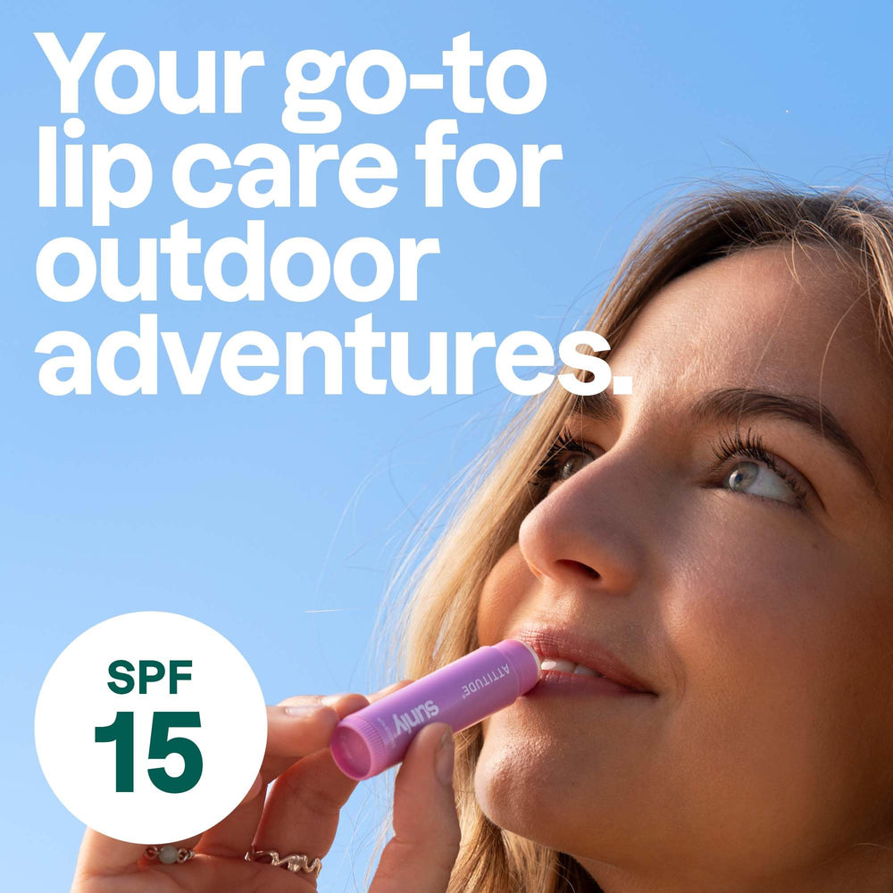 ATTITUDE lip balm held in hand displaying compact travel-friendly size