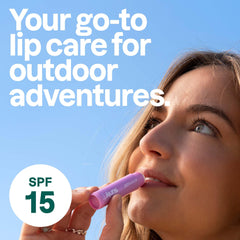 ATTITUDE lip balm held in hand displaying compact travel-friendly size