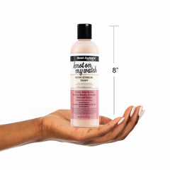 Aunt Jackie's 12 oz bottle held in hand to show actual product size