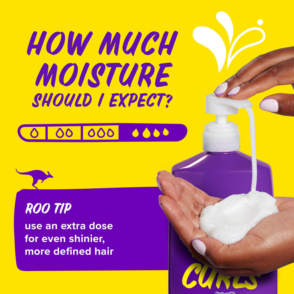 Wide-tooth comb gliding through conditioned curls with Aussie for less breakage