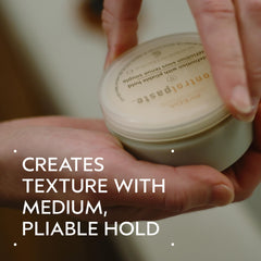 Aveda Control Paste open jar close-up showing creamy texture for easy styling