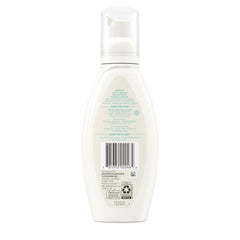 Aveeno bottle beside feverfew sprig linking botanical calming benefit