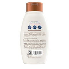 Hand holding 12 fl oz Aveeno bottle to show size and portability