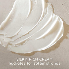 Aveeno conditioner texture poured to show creamy, lightweight consistency