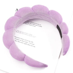 Ayesha headband worn during makeup application showing secure hold benefit: clean forehead