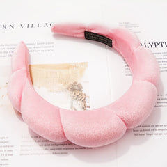 Ayesha headband beside common items to show size and easy travel-friendly convenience