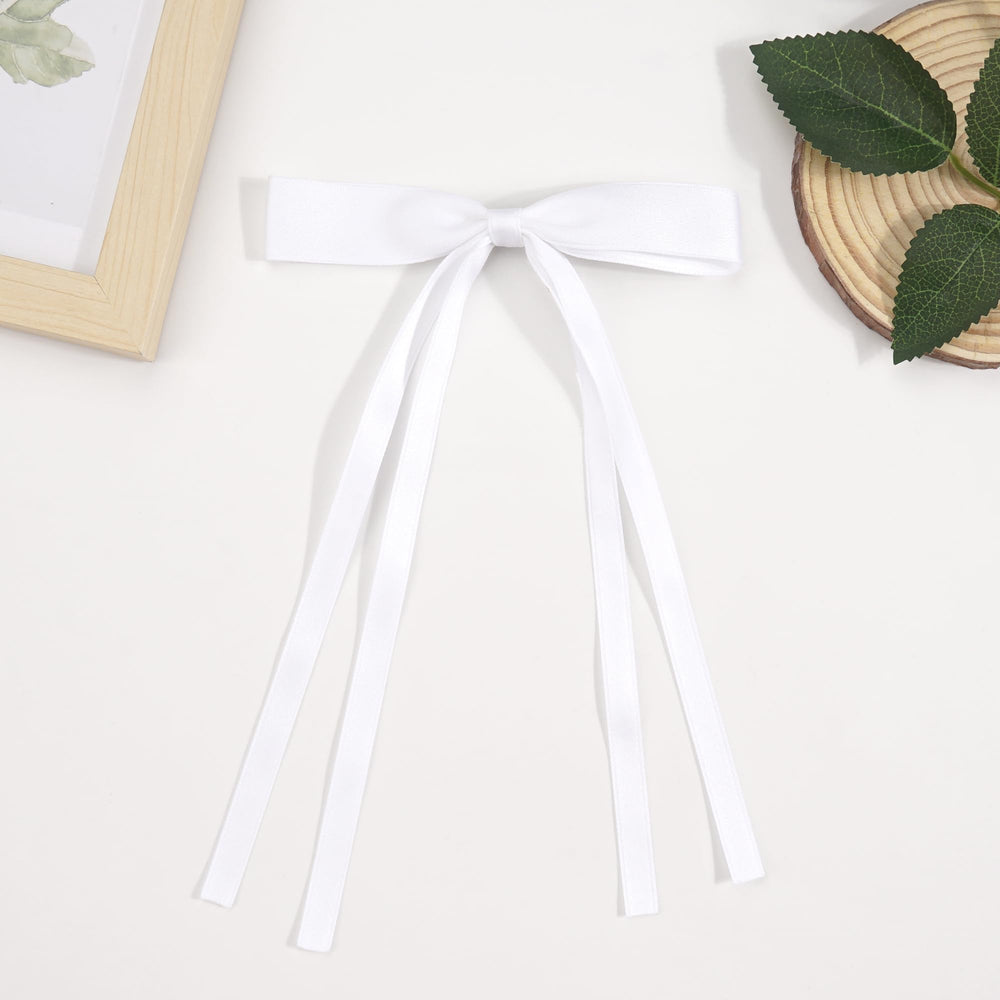 Ayesha bow held in hand showing true size and proportion for gifting