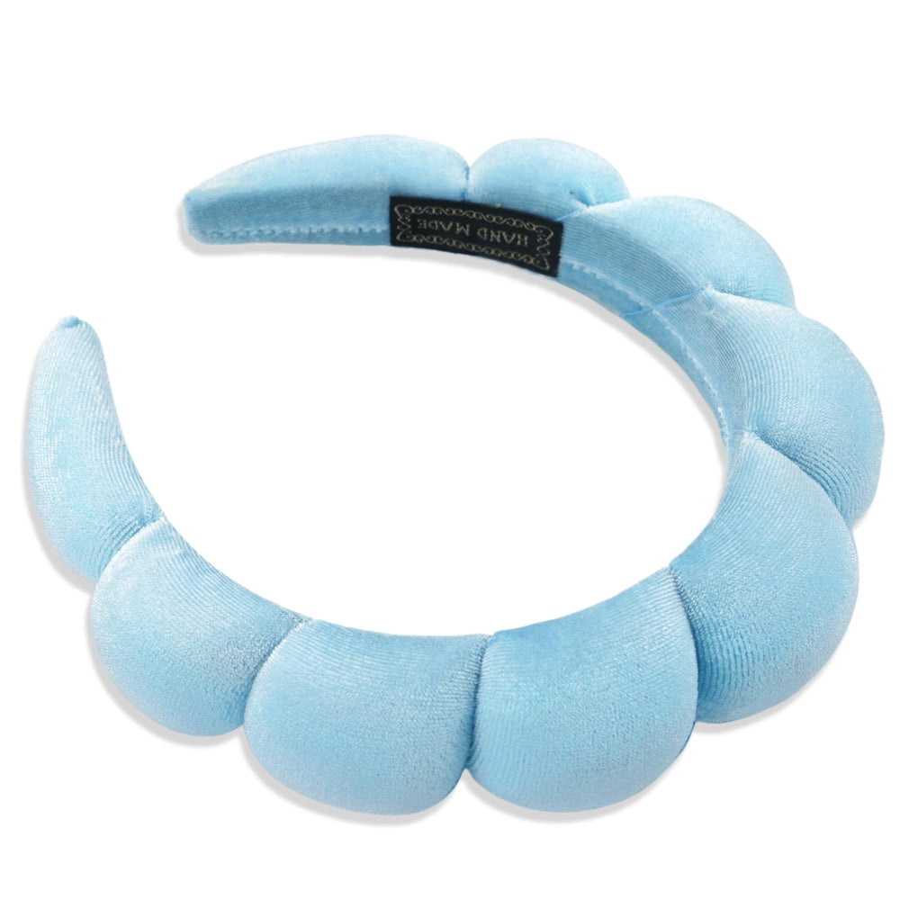 Ayesha headband held in hand for scale showing lightweight design benefit
