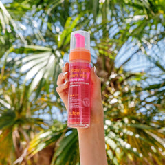 B.TAN lifestyle image at beach radiating glowing skin and confidence benefit