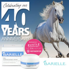 Hand with polish receives Barielle cream under polish to maintain nail health