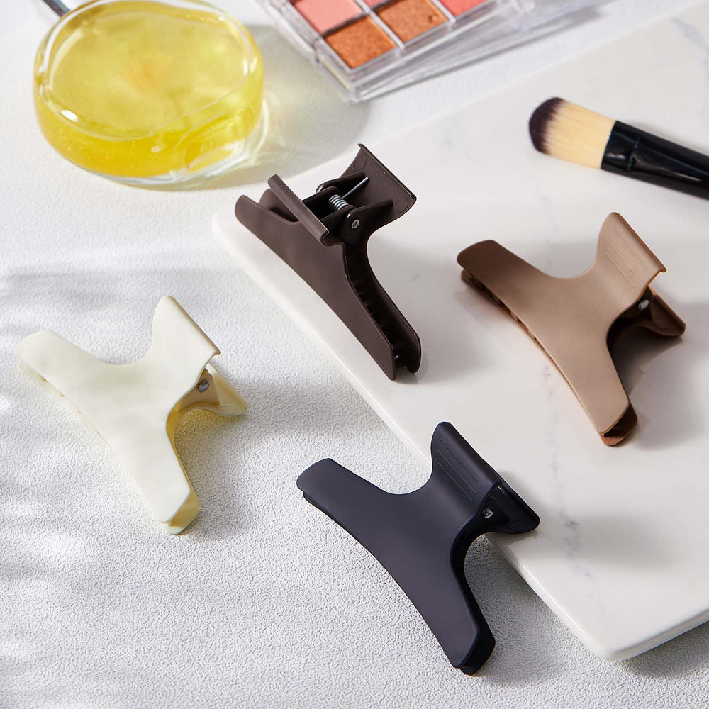 Batiyeer clip holding a thick hair section securely for cutting or coloring