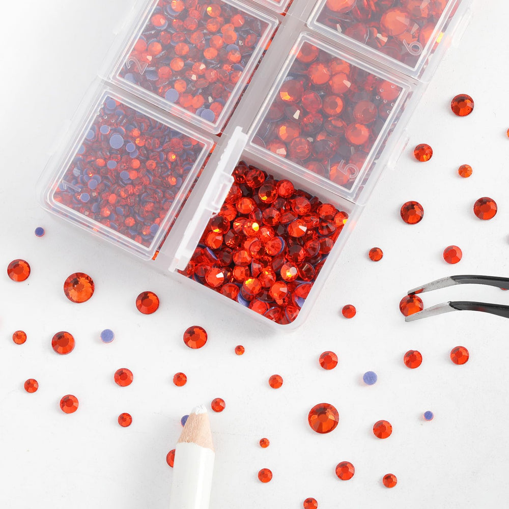 BEADSLAND tweezers and wax pencil picking a rhinestone for precise placement benefit