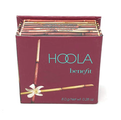 Benefit Hoola with brush in hand demonstrating easy application and quick touchup benefit