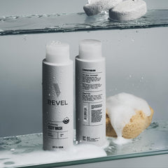 Bevel 16 oz bottle next to toiletries for scale, conveys appropriate bathroom fit