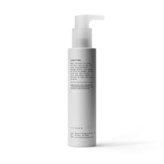 Bevel next to a passport and phone showing compact 3.4 fl oz travel convenience