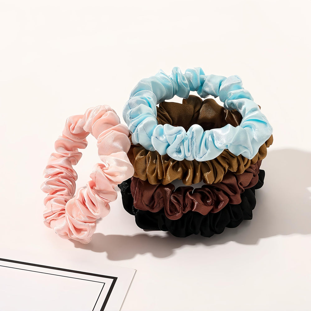 BIEAEIA scrunchie beside a coin showing compact size for travel convenience