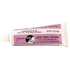 Black and White close-up cream texture on fingertip demonstrating blendable natural correction