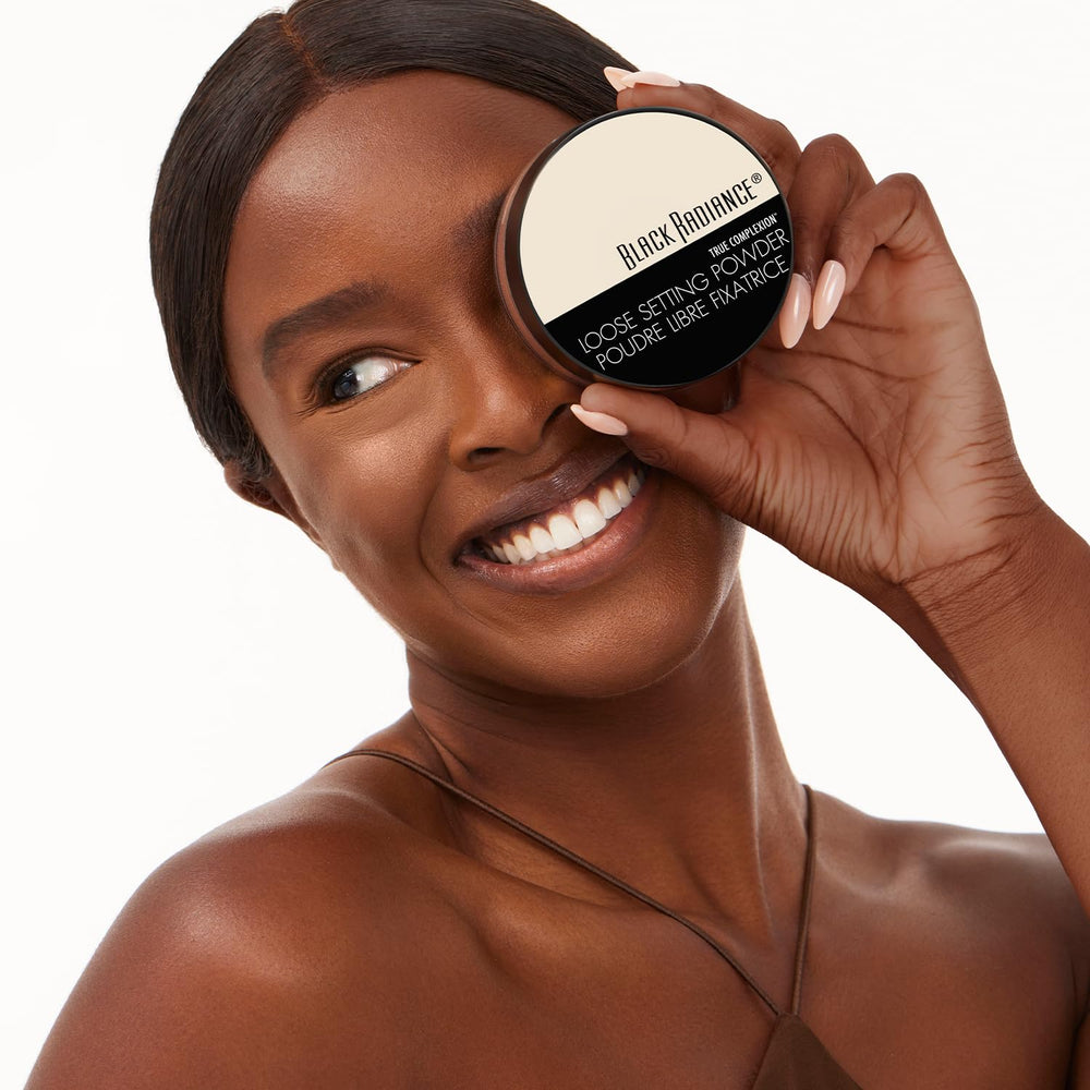 Black Radiance applying powder with brush to set foundation for longer wear