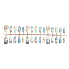 Bloazife nails worn on hand in summer setting adding instant beach-ready style
